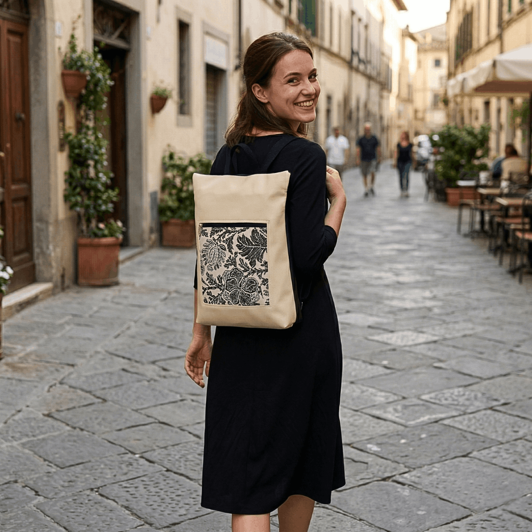 mujer-sonriente-llevando-mochila-antirrobo-paisley-crema-cristina-alba